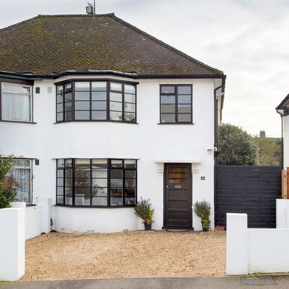 house with white wall and window