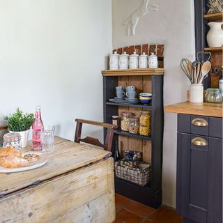 painted kitchen with wooden table and painted cabinet