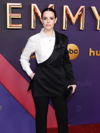 Emily Hampshire wears a black and white Dolce & Gabbana blazer at the brand's Spring/Summer 2024 fashion show.