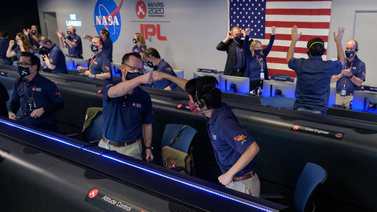 Members of NASA&rsquo;s Perseverance rover team react in mission control after receiving confirmation the spacecraft successfully touched down on Mars, Thursday, Feb. 18, 2021, at NASA's Jet Propulsion Laboratory in Pasadena, California.