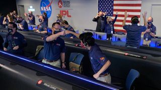 Members of NASA’s Perseverance rover team react in mission control after receiving confirmation the spacecraft successfully touched down on Mars, Thursday, Feb. 18, 2021, at NASA's Jet Propulsion Laboratory in Pasadena, California. 