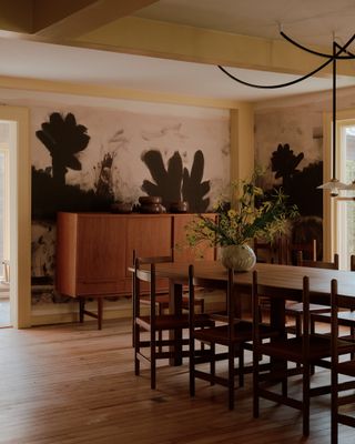 A dining table in front of a credenza at Rachel Cope's art studio in upstate New York