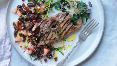 Plate of food with a piece of grilled fish and cherry and peach salsa
