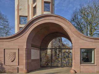 Gradel Quadrangles in Oxford with its pink hued exterior and curved shapes and gargoyles