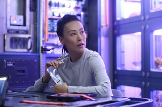 Lu (Vivian Wu) has some space refreshments aboard the Atlas in