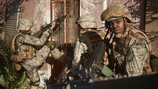 Three US soldiers breach a door