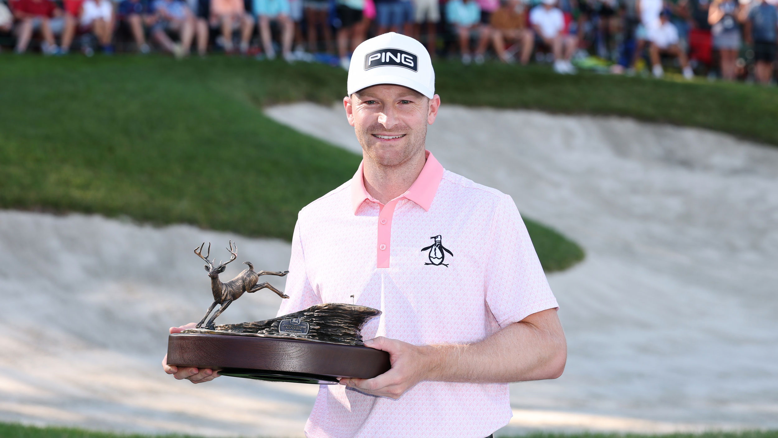 Brian Campbell poses with the John Deere Classic trophy after winning in 2025