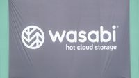 A photo of the Wasabi logo on a flag with the subtitle "Hot cloud storage". Decorative: the flag is black, while the Wasabi logo is white.