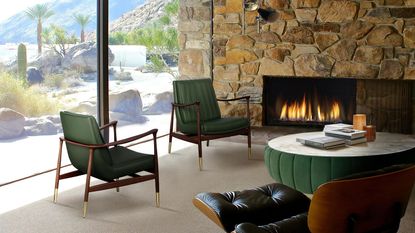 Green chairs in living room with stone wall and fireplace