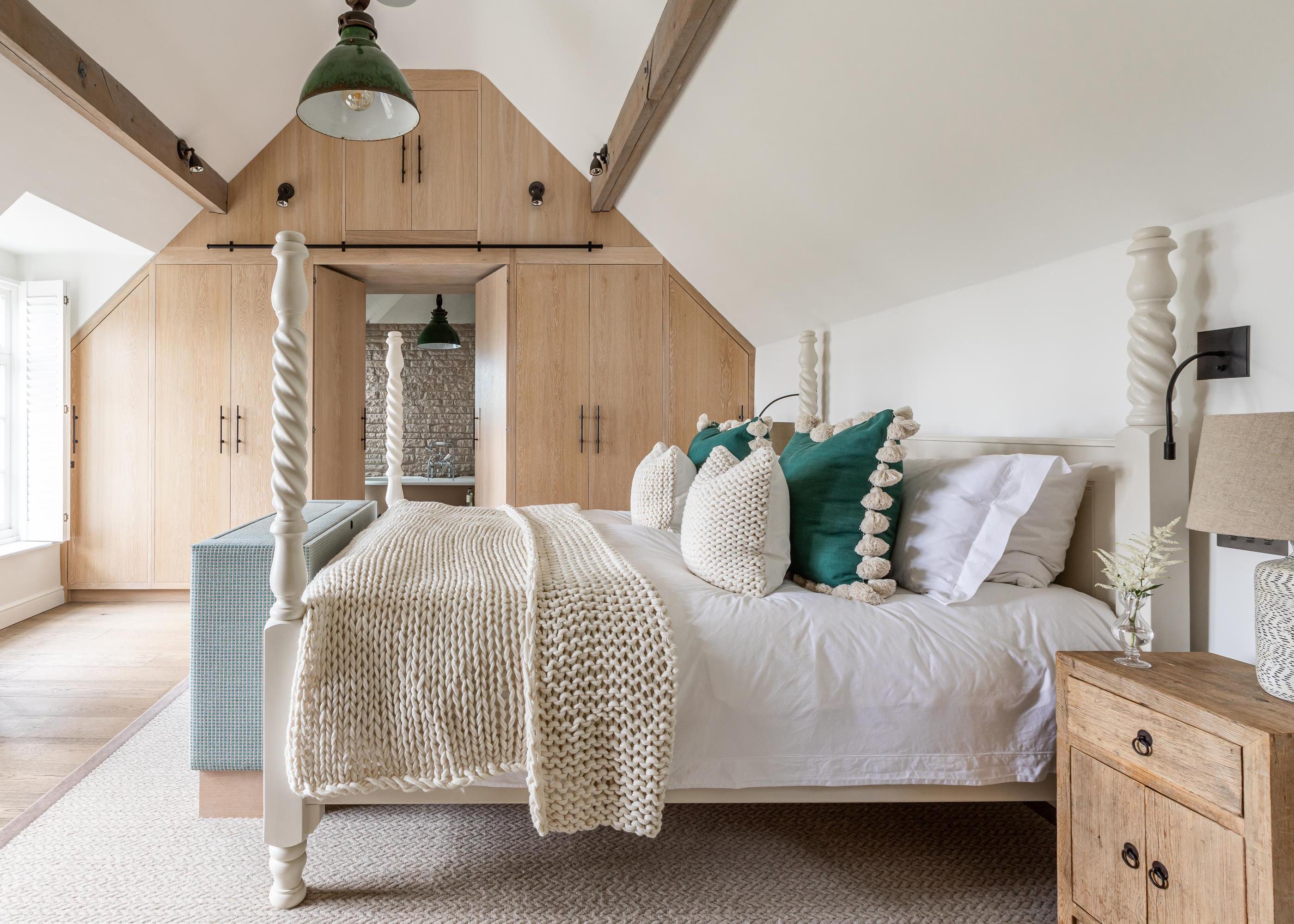 loft with four poster and timber wardrobes