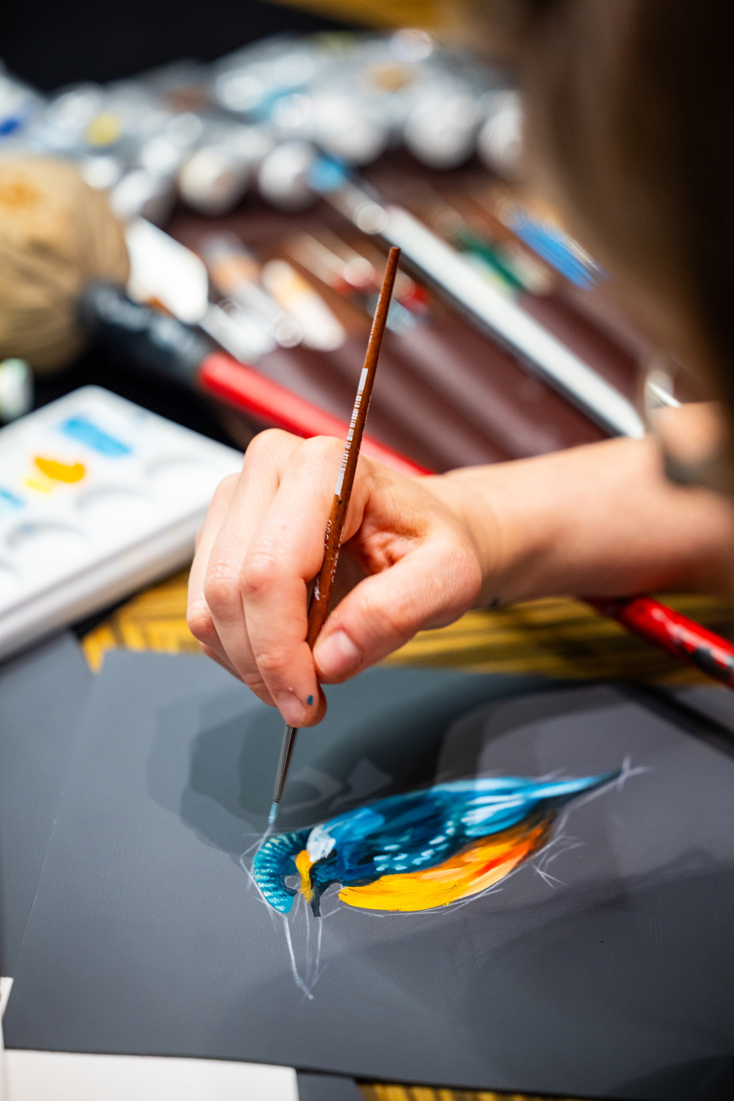 Images of Rolls Royce craftspersons creating a triptych of nature scenes featuring a kingfisher