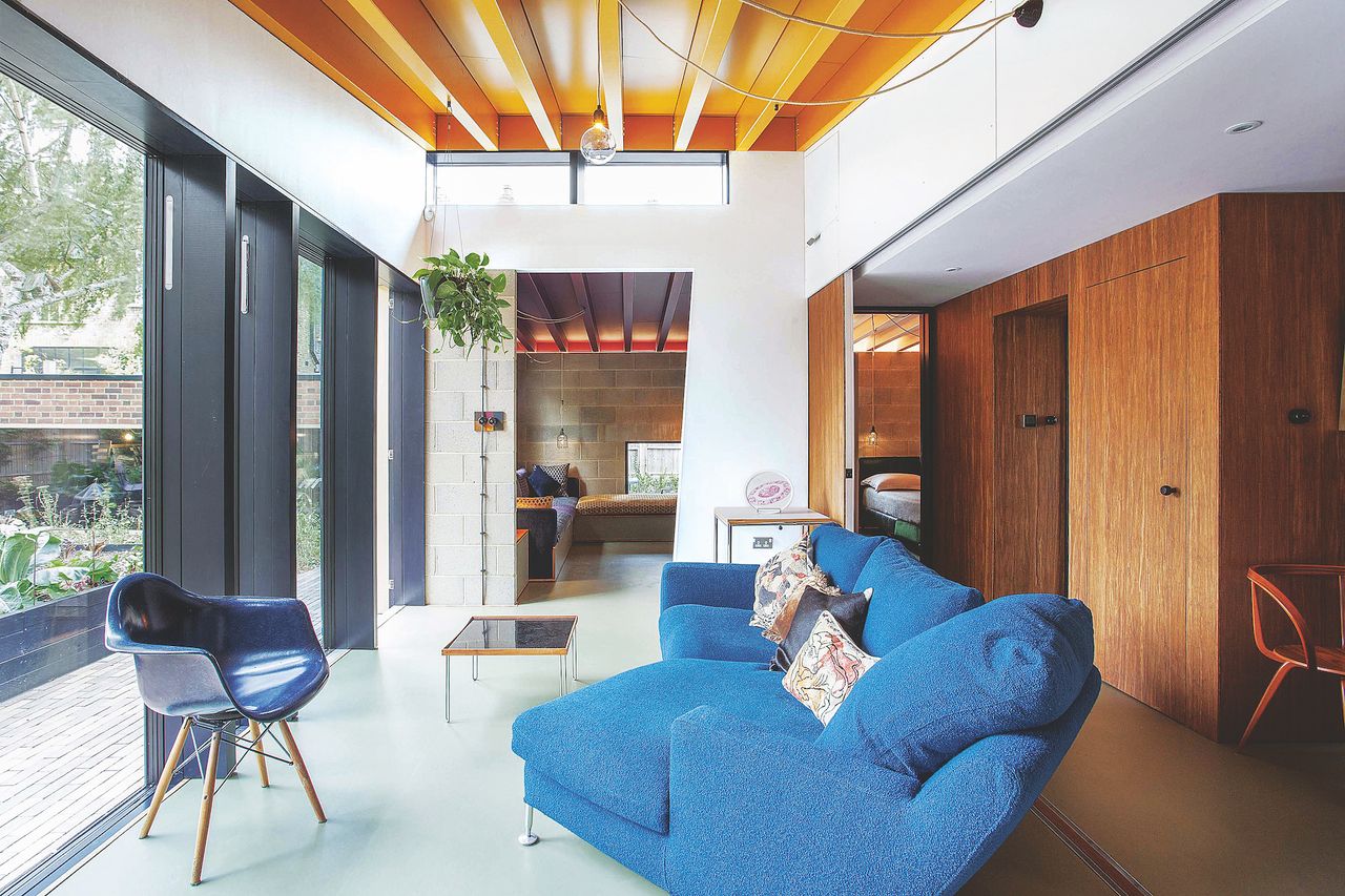 living room with large pocket doors and blue sofa