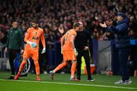 Antonin Kinsky of Tottenham Hotspur leaves the pitch after being substituted off in the 17th minute, and is replaced by Guglielmo Vicario of Tottenham Hotspur during the UEFA Champions League 2025/26 Round of 16 First Leg match between Atletico de Madrid and Tottenham Hotspur FC at Estadio Civitas Metropolitano on March 10, 2026 in Madrid, Spain.