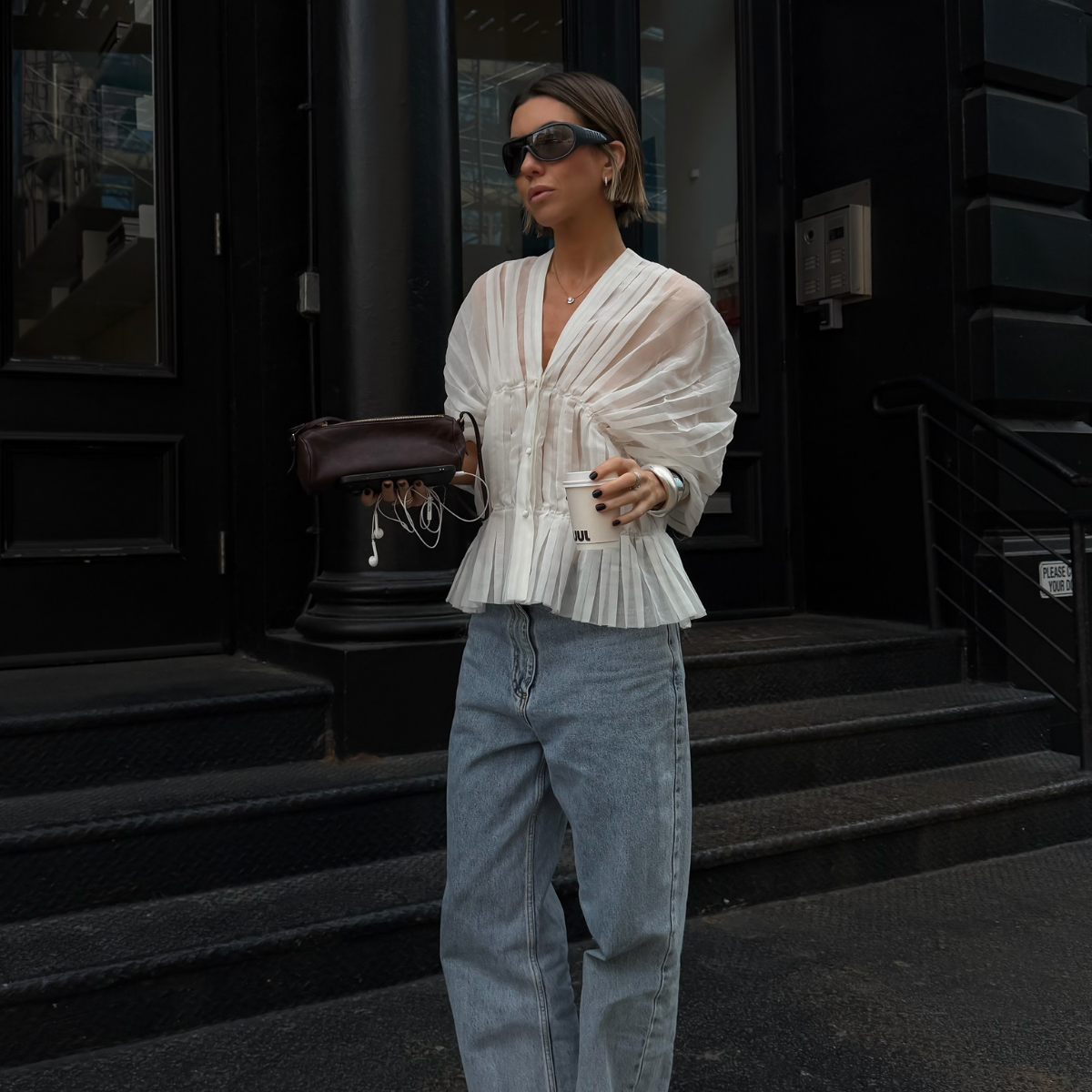 An image of a woman wearing jeans black sandals outfit 2026