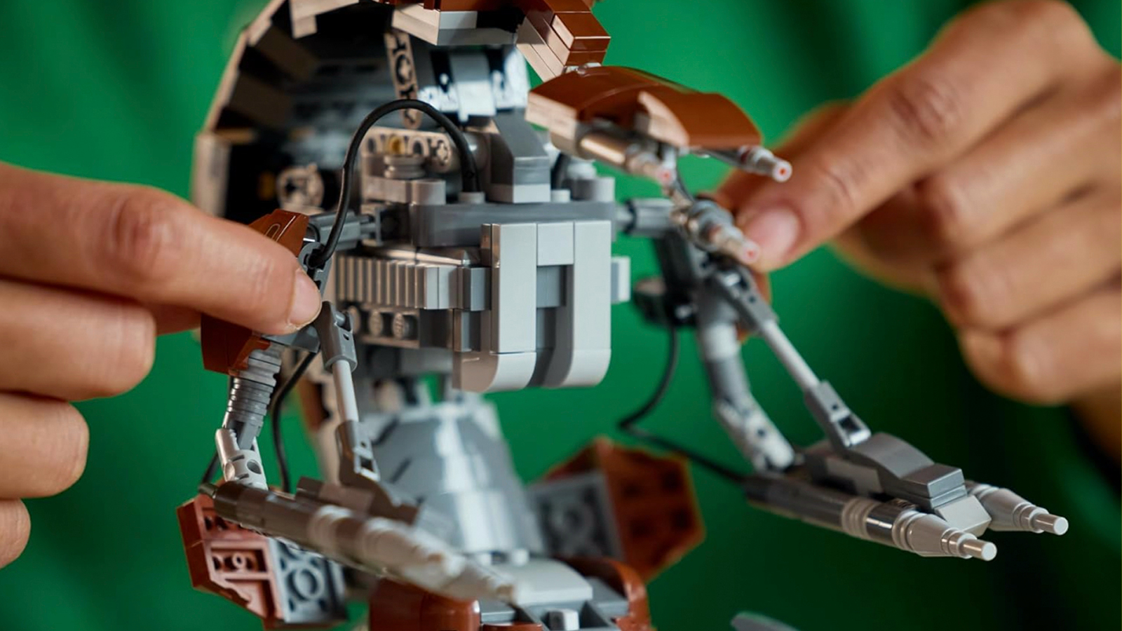 A LEGO Star Wars Droideka figure being operated by a builder