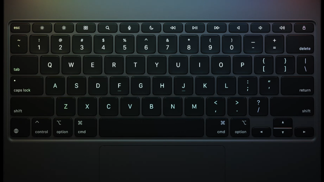A close up from above of the Magic Keyboard, lit up by the screen