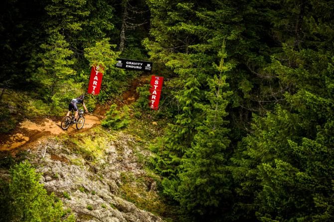 A racer enters an enduro section of the BC Bike Race