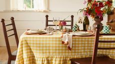 Table with yellow gingham tablecloth and green checkerboard drinkware