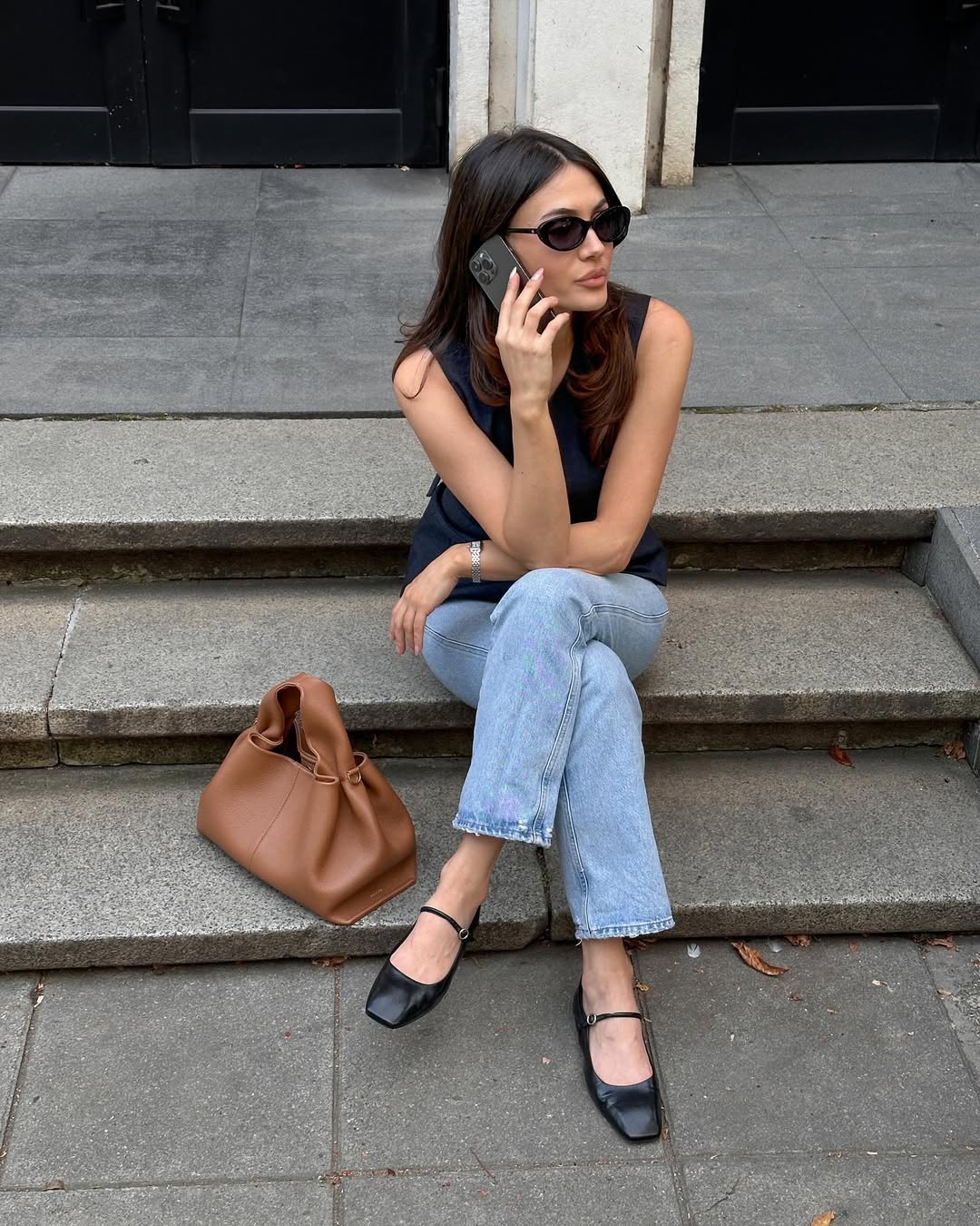 Woman wearing cropped jeans and ballet flats.