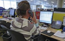 Woman in open plan office working on computer on the phone and checking emails H&H 21/05/2009 pub orig