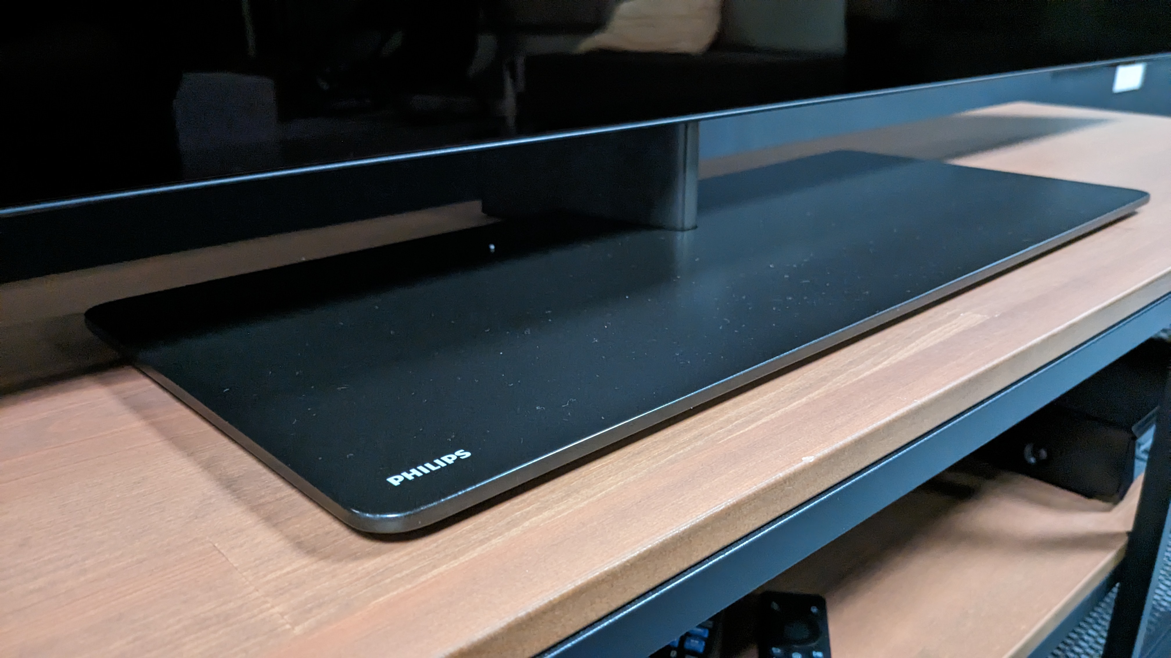 Philips OLED808 stand on light brown bench