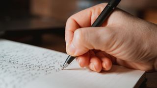 Person writing on paper