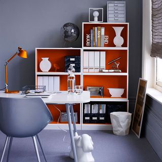 home office room with blue wall and wooden shelves