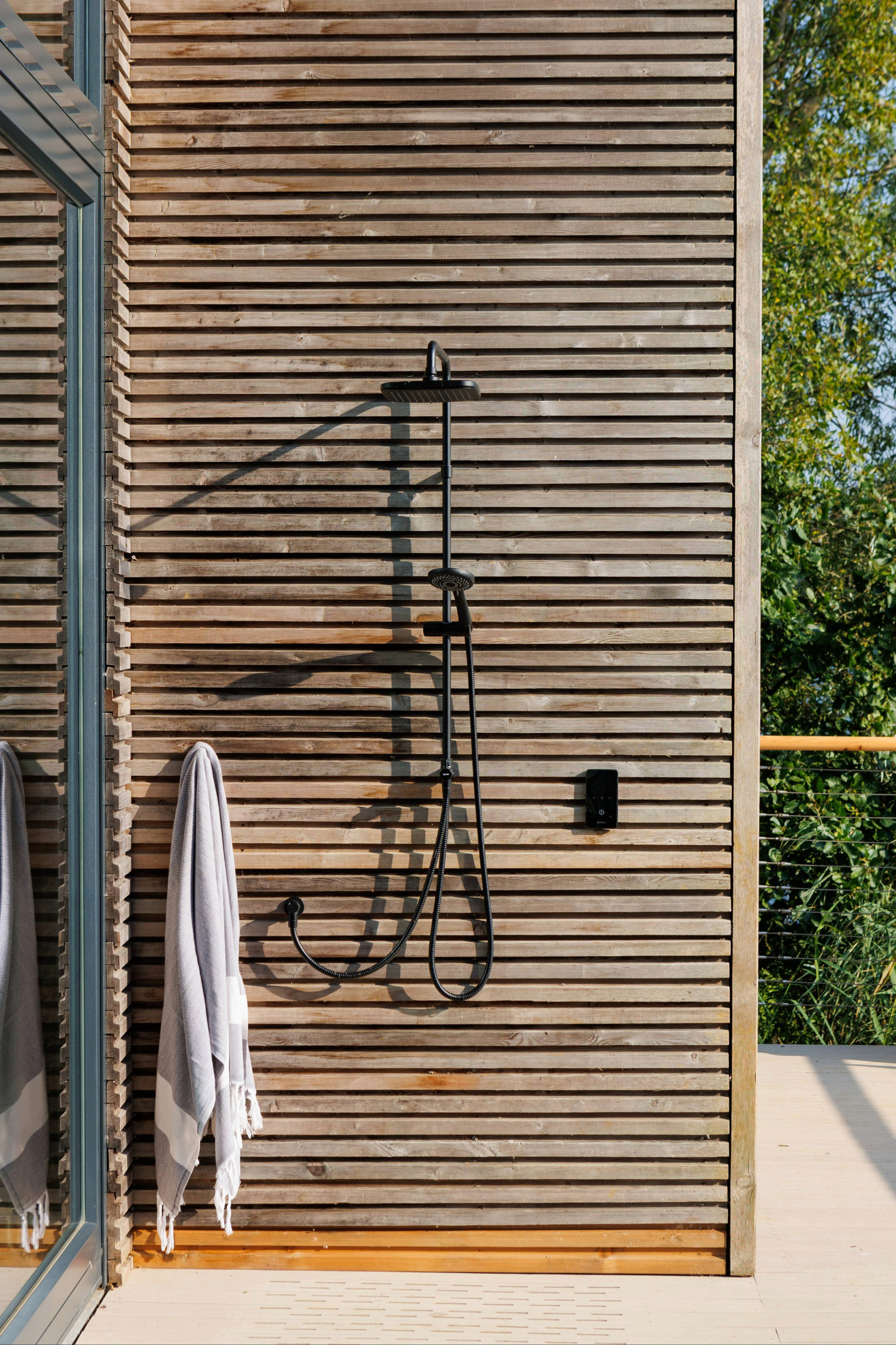 Outdoor shower featuring slatted wooden screen