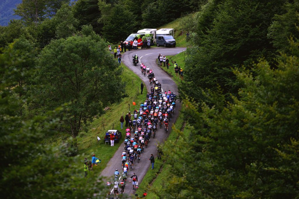 SAINTGAUDENS FRANCE JULY 13 Tadej Pogaar of Slovenia and UAETeam Emirates yellow leader jersey The peloton passing through Col de la Core 1395m landscape during the 108th Tour de France 2021 Stage 16 a 169km stage from Pas de la Casa to SaintGaudens LeTour TDF2021 on July 13 2021 in SaintGaudens France Photo by Tim de WaeleGetty Images