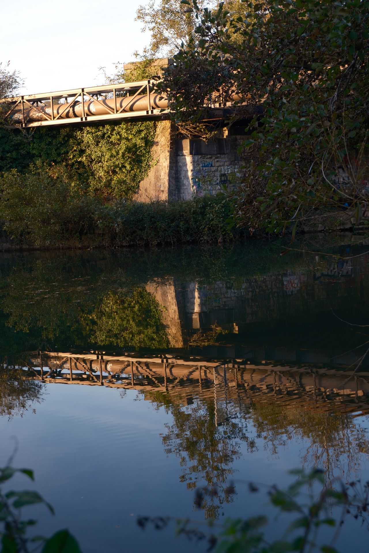 A photo of a bridge and its reflection in the water taken on a Fujifilm X-M5 camera