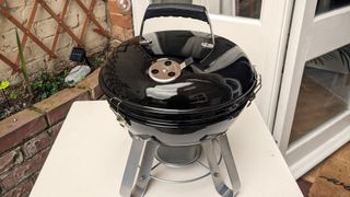 Napoleon NK14 Portable Charcoal Kettle Grill being tested in writer's home