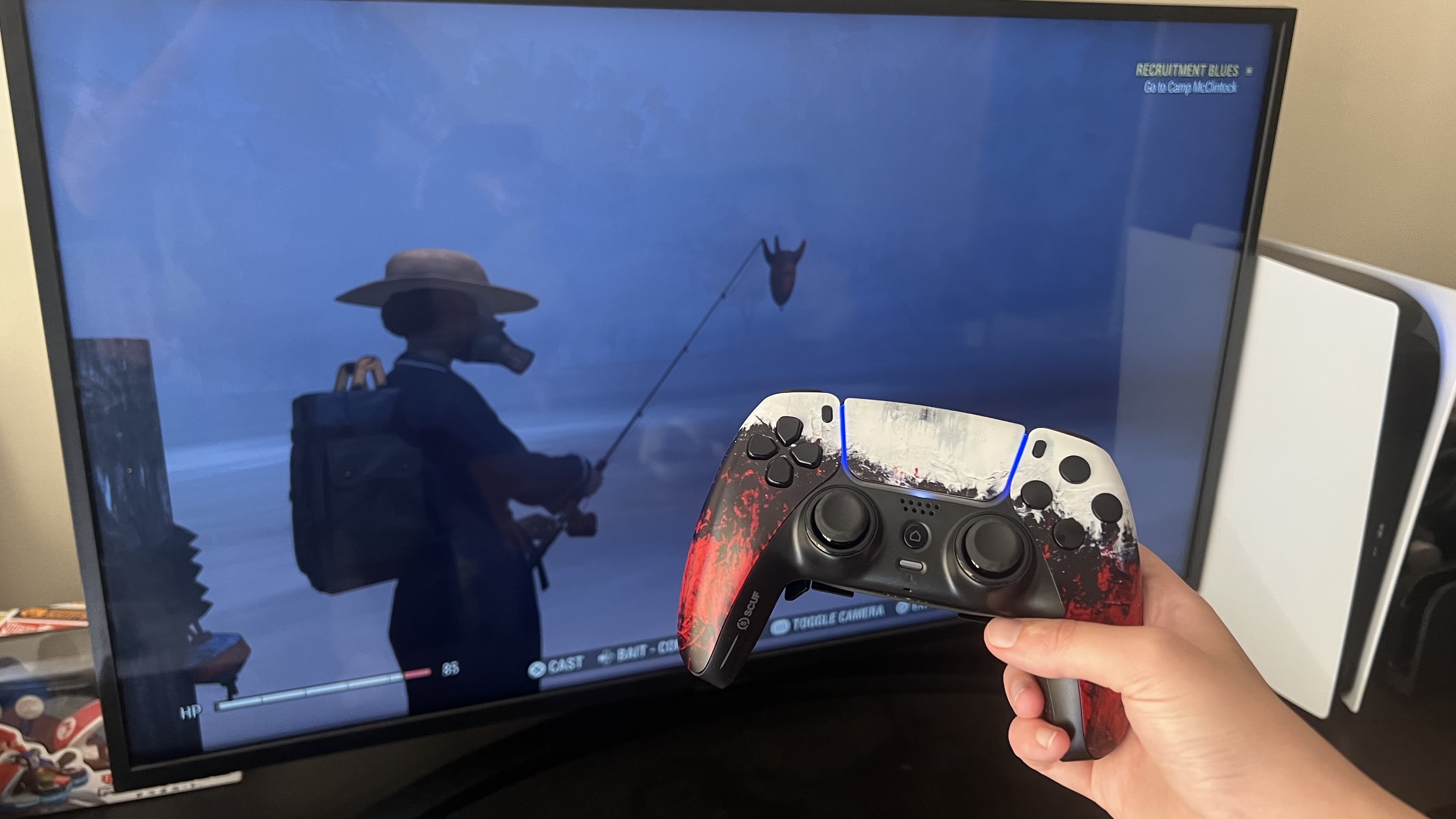 Scuf Reflex controller held against a TV displaying Fallout 76 fishing