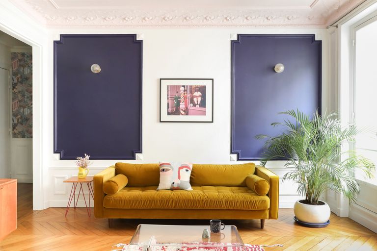 a living room with contrast painted wall paneling