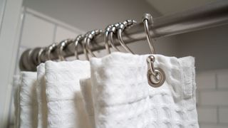 Shower hooks holding a shower curtain in place