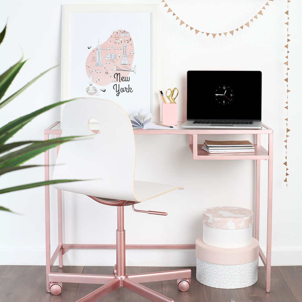 room with laptop on pink table and chair