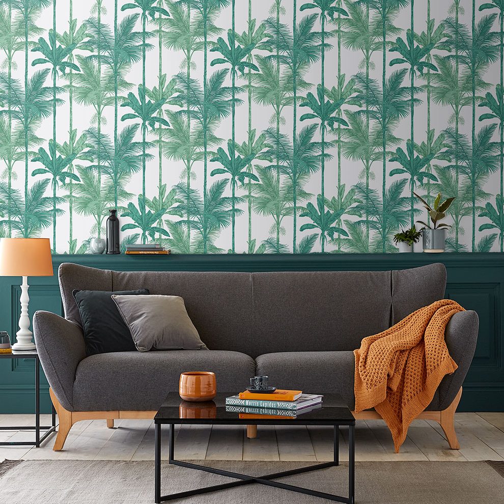 tropical bamboo wallpaper in living room with grey sofa and orange accents
