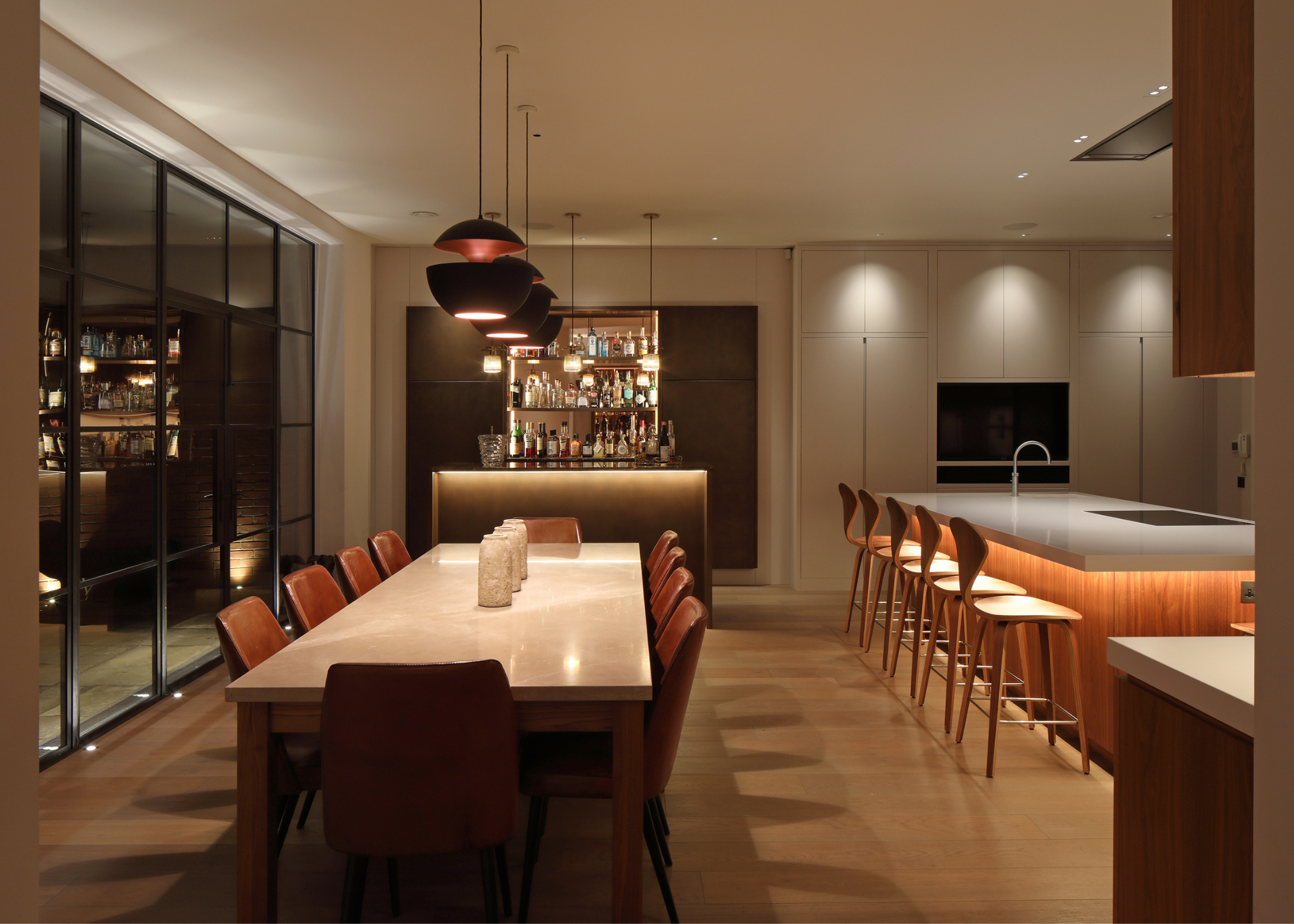 a rich layered lighting scheme in a modern kitchen with crittal doors