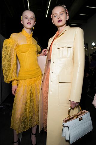 models posing with yellow dress and ivory jacket