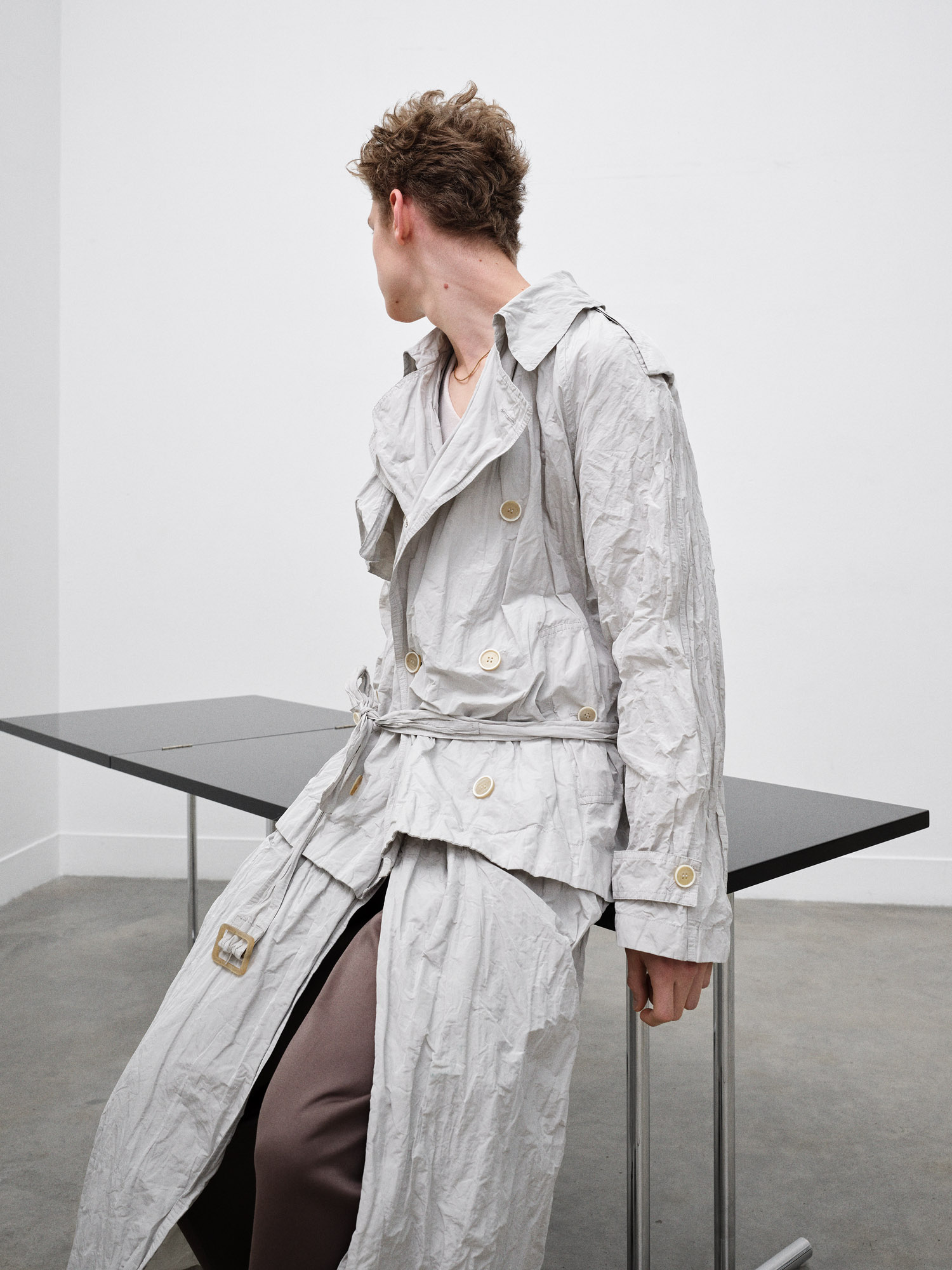 fashion shoot, man sat on eileen gray's lou perou table