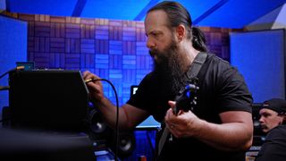 John Petrucci adjusting his amp settings