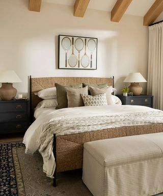 mcgee and co spring collection bedroom with wooden beams and a rattan bed