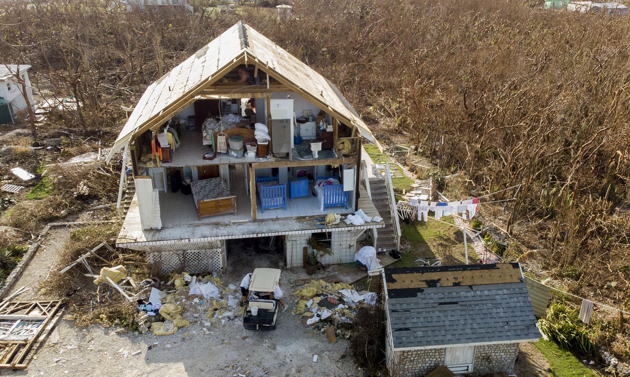 A house with its front torn off, exposing the inside