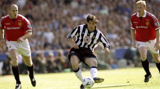 22 May 1999: Silvio Maric of Newcastle United shoots at the goal and misses badly with Jaap Stam and David May of Manchester United watching on during the AXA FA Cup Final match against Manchester United played at Wembley Stadium in London, England. The match finished in a 2-0 win for Manchester United and they achieved the "Double" for the third time in six years. \ Mandatory Credit: Shaun Botterill /Allsport