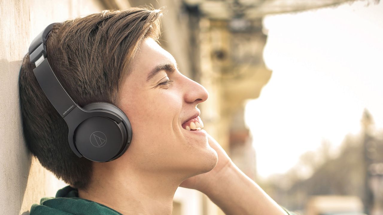 Audio-Technica ATH-S220BT in black worn by man outside