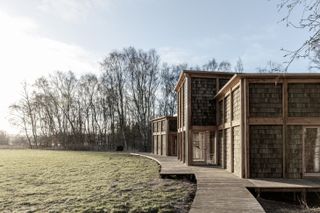 House of Nature by Revaerk Arkitektur, approaching from the timber decked footpath