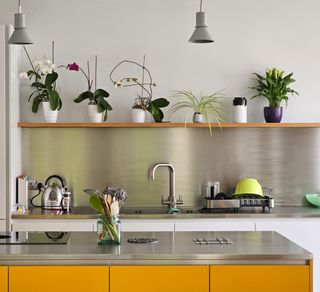 A kitchen with stainless steel backsplash