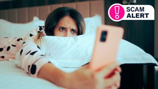 Woman on bed looking at phone.