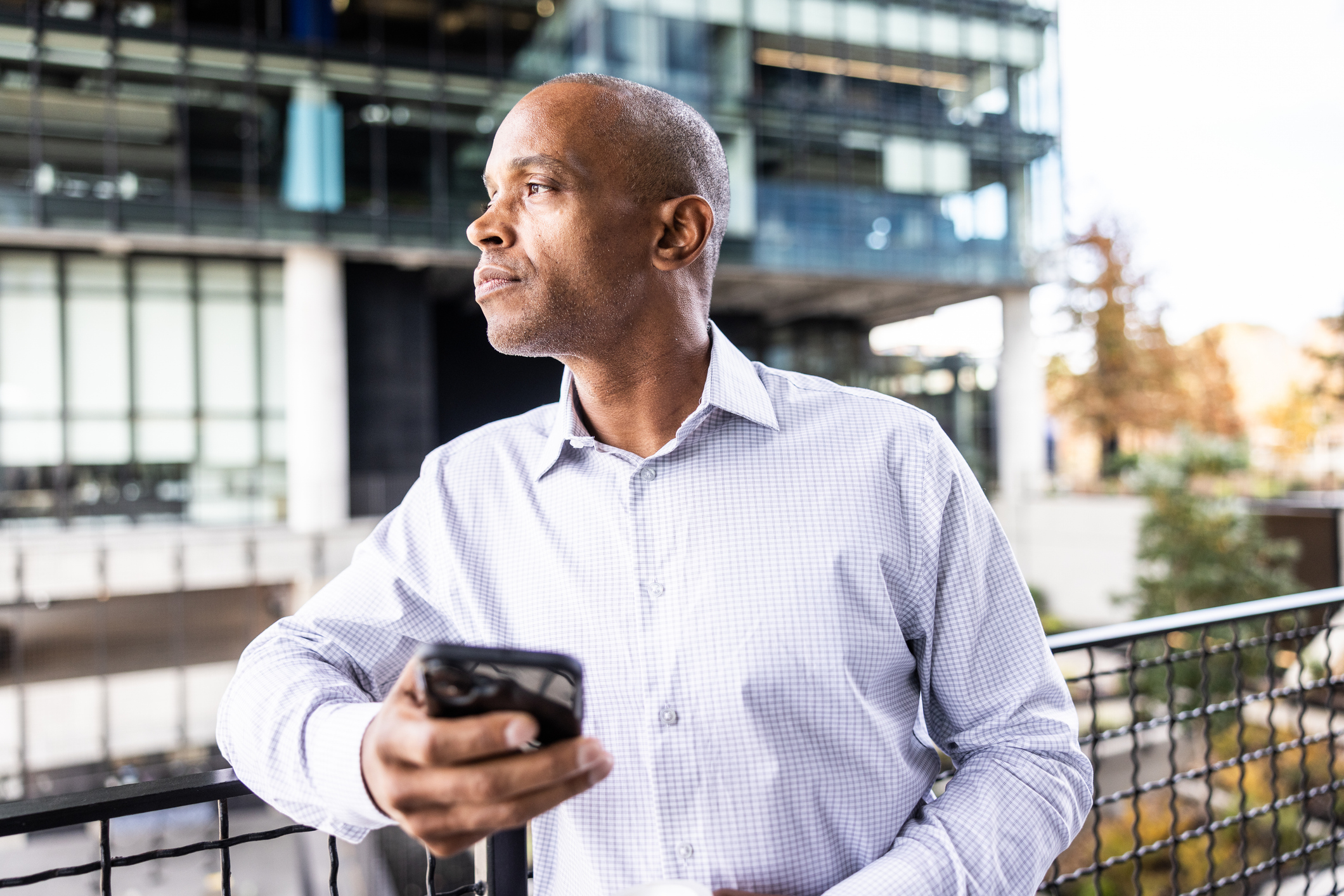 Businessman using smartphone in outdoor urban environment