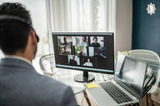 Man working on computer doing a web conference at home