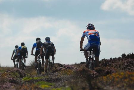 Riding through the heather towards the summit